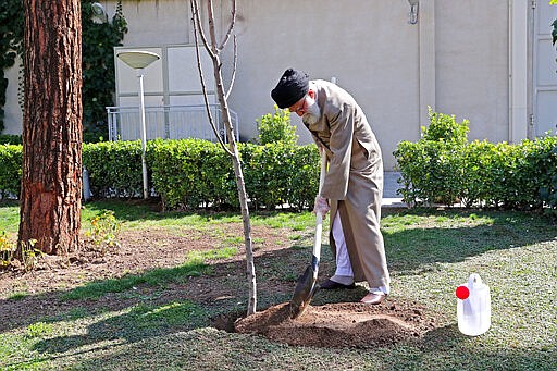 In this photo released by an official website of the office of the Iranian supreme leader, Supreme Leader Ayatollah Ali Khamenei participates in a tree planting ceremony in Tehran, Iran, Tuesday, March 3, 2020. Iran's supreme leader put the Islamic Republic on war footing Tuesday against the new coronavirus by ordering its armed forces to assist health officials in combating the outbreak &#151; the deadliest outside of China &#151; that authorities say has killed 77 people. (Office of the Iranian Supreme Leader via AP)