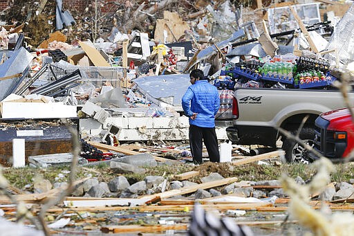 A man looks for items he can salvage from his store Tuesday, March 3, 2020, near Cookeville, Tenn. Tornadoes ripped across Tennessee early Tuesday, shredding more than 140 buildings and burying people in piles of rubble and wrecked basements. At least 22 people were killed. (AP Photo/Mark Humphrey)