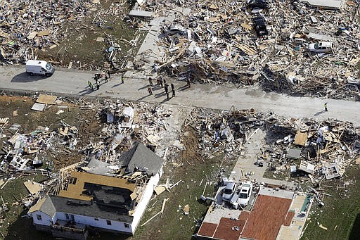 Emergency personnel work among destroyed homes Tuesday, March 3, 2020, near Cookeville, Tenn. Tornadoes ripped across Tennessee early Tuesday, shredding more than 140 buildings and burying people in piles of rubble and wrecked basements. At least 22 people were killed. (AP Photo/Mark Humphrey)