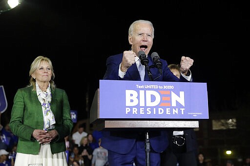 Democratic presidential candidate former Vice President Joe Biden, right, speaks next to his wife Jill during a primary election night rally Tuesday, March 3, 2020, in Los Angeles. (AP Photo/Marcio Jose Sanchez)