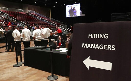 FILE - In this Tuesday, June 4, 2019, file photo, managers wait for job applicants at the Seminole Hard Rock Hotel &amp; Casino Hollywood during a job fair in Hollywood, Fla.  U.S. businesses added 183,000 jobs in Jan. 2020, a solid gain that shows the economy was largely healthy when the coronavirus outbreak spread further around the globe. Large companies added roughly two-thirds of the jobs, while hiring among smaller firms was relatively weak. Manufacturing and mining firms shed jobs, while hiring in health care and hotels and restaurants was strong. (AP Photo/Wilfredo Lee, File)