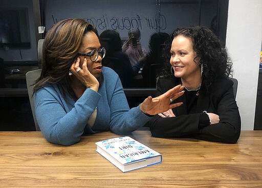 In this Feb. 13, 2020 photo, Oprah Winfrey, left, and &#147;American Dirt&quot; author Jeanine Cummins appear in a conference room just above Modern Studios in Tucson, Ariz., where they taped an Oprah's Book Club show about Cummins' controversial book. The two-part interview will begin streaming on Apple TV Plus at midnight ET on Friday, March 6. (AP Photo/Hillel Italie)