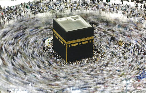 In this picture taken with a slow shutter speed, far smaller crowds than usual of Muslim pilgrims circumambulate the Kaaba, the cubic building at the Grand Mosque, in the Muslim holy city of Mecca, Saudi Arabia, Wednesday, March 4, 2020. The coronavirus outbreak disrupted Islamic worship in the Middle East as Saudi Arabia on Wednesday banned its citizens and other residents of the kingdom from performing the pilgrimage in Mecca, while Iran canceled Friday prayers in major cities. (AP Photo/Amr Nabil)