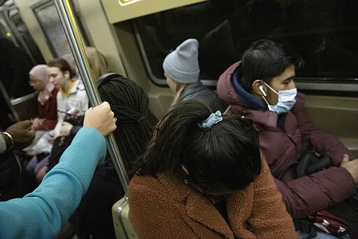 A commuter holds on to a vertical pole while another wears a mask as they ride the subway, Wednesday, March 4, 2020, in New York. &quot;It may be possible that a person can get COVID-19 by touching a surface or object that has the virus on it and then touching their own mouth, nose, or possibly their eyes, but this is not thought to be the main way the virus spreads,&quot; according to the Centers for Disease Control and Prevention, (CDC). (AP Photo/Mark Lennihan)