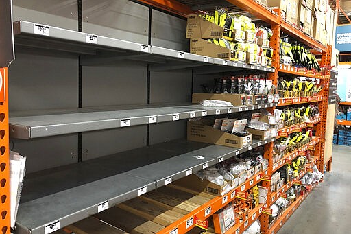 Shelves that previously held masks and respirators are bare at a Home Depot Store in Seattle, Tuesday, March 3, 2020. In addition to the shortages of hand sanitizer, hospitals are more concerned about a shortage of face masks, which people have been snatching up despite pleas from health officials. (AP Photo/Ted S. Warren)