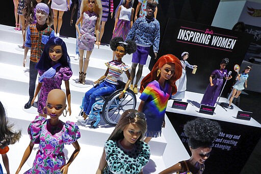 A diverse line of Barbies, including one depicting alopecia, foreground left, one in a wheelchair, and three Inspiring Women, right, are displayed at Toy Fair New York, in the Javits Convention Center, Monday, Feb. 24, 2020.  From Baby Yoda to eco-friendly stacking rings, toymakers displayed an array of goods that they hope will be on kids' wish lists for the holiday 2020 season. The four-day Toy Fair comes as the U.S. toy industry has been whipsawed by a number of obstacles.  (AP Photo/Richard Drew)