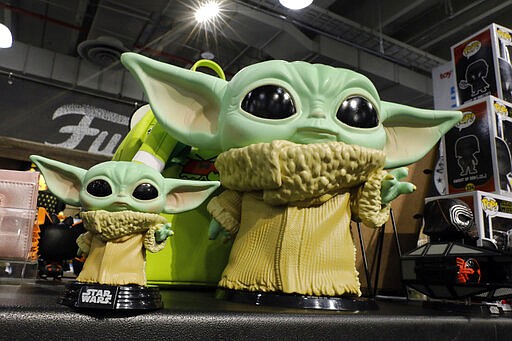 A pair of Funko's Pop! Baby Yoda figures are displayed at Toy Fair New York, in the Javits Convention Center, Monday, Feb. 24, 2020.  From Baby Yoda to eco-friendly stacking rings, toymakers displayed an array of goods that they hope will be on kids' wish lists for the holiday 2020 season. The four-day Toy Fair comes as the U.S. toy industry has been whipsawed by a number of obstacles.  (AP Photo/Richard Drew)