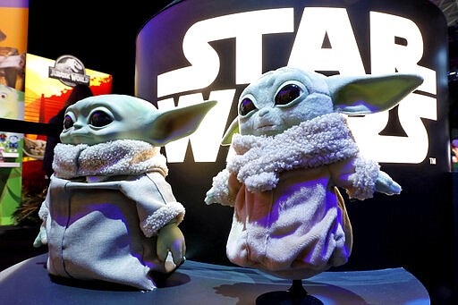 A pair of Baby Yoda dolls, by Mattel, are displayed at Toy Fair New York, in the Javits Convention Center, Monday, Feb. 24, 2020. From Baby Yoda to eco-friendly stacking rings, toymakers displayed an array of goods that they hope will be on kids' wish lists for the holiday 2020 season. The four-day Toy Fair comes as the U.S. toy industry has been whipsawed by a number of obstacles.  (AP Photo/Richard Drew)