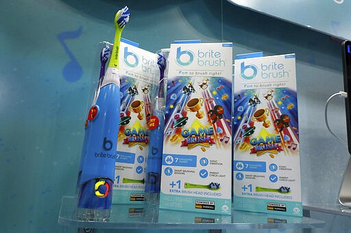 The BriteBrush interactive toothbrush, from WowWee, is displayed at Toy Fair New York, in the Javits Convention Center, Monday, Feb. 24, 2020.  From Baby Yoda to eco-friendly stacking rings, toymakers displayed an array of goods that they hope will be on kids' wish lists for the holiday 2020 season. The four-day Toy Fair comes as the U.S. toy industry has been whipsawed by a number of obstacles.   (AP Photo/Richard Drew)