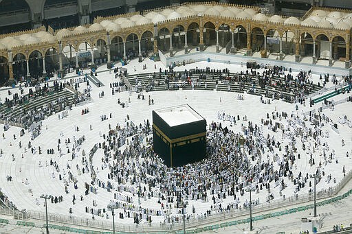 A relatively few number of Muslims pray around the Kaaba, the cubic building at the Grand Mosque, in the Muslim holy city of Mecca, Saudi Arabia, Wednesday, March 4, 2020. On Wednesday, Saudi Arabia's Deputy Health Minister Abdel-Fattah Mashat was quoted on the state-linked news site Al-Yaum saying that groups of visitors to Mecca from inside the country would now also be barred from performing the pilgrimage, known as the umrah. (AP Photo/Amr Nabil)