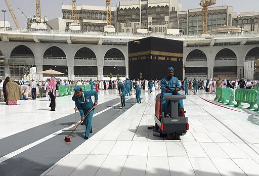 Workers clean the Grand Mosque, during the minor pilgrimage, known as Umrah, in the Muslim holy city of Mecca, Saudi Arabia, Monday, March 2, 2020. At Islam&#146;s holiest site in Mecca, restrictions put in place by Saudi Arabia to halt the spread of the new coronavirus saw far smaller crowds than usual on Monday. (AP Photo/Amr Nabil)