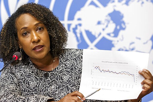 Pamela Coke-Hamilton, Director of the Division on International Trade and Commodities at the United Nations Conference on Trade and Development, UNCTAD, presents an UNCTAD's analysis on the impacts of new coronavirus COVID-19 on global value chains during a press conference at the European headquarters of the United Nations in Geneva, Switzerland, Wednesday, March 4, 2020. (Salvatore Di Nolfi/Keystone via AP)