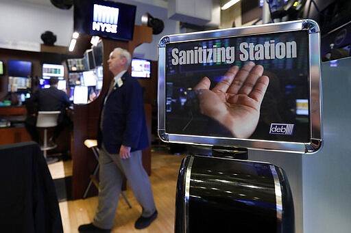 A trader passes a hand sanitizing station on the floor of the New York Stock Exchange, Tuesday, March 3, 2020. Federal Reserve Chairman Jerome Powell noted that the coronavirus &quot;poses evolving risks to economic activity.&quot; (AP Photo/Richard Drew)