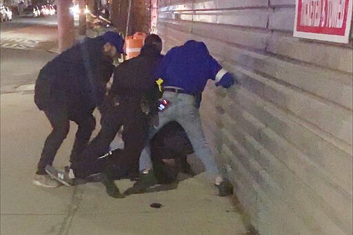 In this image made from video, New York City police officers forcefully arrest 20-year-old Fitzroy Gayle in the Brooklyn borough of New York, Wednesday, March 4, 2020. The widely distributed video sparked outrage and elicited questions about the amount of force used to make the arrest in a city still dealing with mistrust over the 2014 police chokehold death of Eric Garner. (AP Photo/User Generated Content)