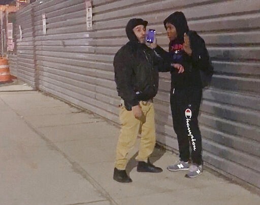 In this image made from video, a New York City police officer in plain clothes, left, confronts 20-year-old Fitzroy Gayle prior to him being forcefully arrested by a team of officers in the Brooklyn borough of New York, Wednesday, March 4, 2020. The widely distributed video sparked outrage and elicited questions about the amount of force used to make the arrest in a city still dealing with mistrust over the 2014 police chokehold death of Eric Garner. (AP Photo/User Generated Content)