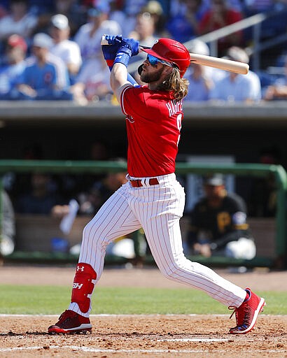 Philadelphia Phillies' Bryce Harper watches his two-run home run during the fourth inning of a spring training baseball game against the Pittsburgh Pirates, Wednesday, March 4, 2020, in Clearwater, Fla. (AP Photo/Carlos Osorio)