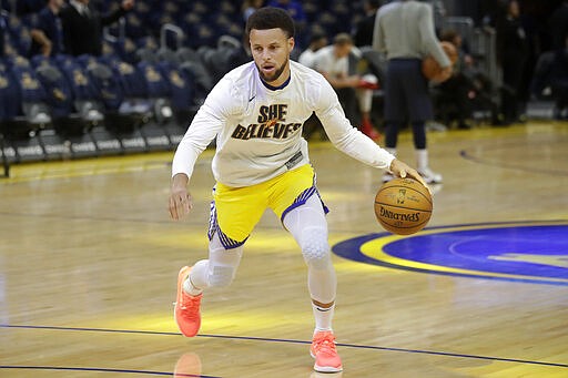 Injured Golden State Warriors guard Stephen Curry warms up before his team's NBA basketball game against the Washington Wizards in San Francisco, Sunday, March 1, 2020. (AP Photo/Jeff Chiu)