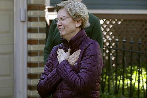 Sen. Elizabeth Warren, D-Mass., acknowledges supporters as she arrives to speak to the media outside her home, Thursday, March 5, 2020, in Cambridge, Mass., after she dropped out of the Democratic presidential race. (AP Photo/Steven Senne)