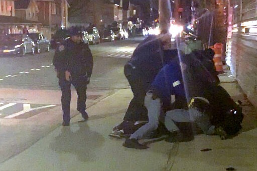 In this image made from video, New York City police officers forcefully arrest 20-year-old Fitzroy Gayle in the Brooklyn borough of New York, Wednesday, March 4, 2020. The widely distributed video sparked outrage and elicited questions about the amount of force used to make the arrest in a city still dealing with mistrust over the 2014 police chokehold death of Eric Garner. (AP Photo/User Generated Content)