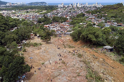 Rescue workers, residents, and volunteers search for victims after a mudslide caused by heavy rains in the coastal city of Guaruja, Brazil, Wednesday, March 4, 2020. Storms have pummeled Brazil&#146;s southeastern coast, causing deadly landslides and leaving people homeless. (AP Photo/Andre Penner)