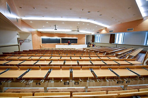 A teacher gives on-line lessons via webcam at the Politecnico University in Milan, Italy, Thursday, March 5, 2020. Italy's virus outbreak has been concentrated in the northern region of Lombardy, but fears over how the virus is spreading inside and outside the country has prompted the government to close all schools and Universities nationwide for two weeks. (Claudio Furlan/LaPresse via AP)