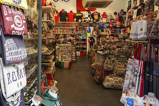 A souvenirs empty shop in Rome, Thursday, March 5, 2020. Italy's virus outbreak has been concentrated in the northern region of Lombardy, but fears over how the virus is spreading inside and outside the country has prompted the government to close all schools and Universities nationwide for two weeks. (AP Photo/Andrew Medichini)