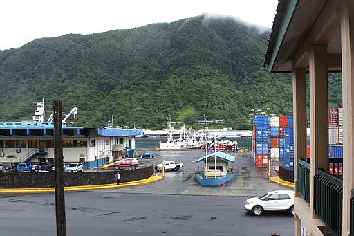 This Wednesday, March 4, 2020, photo shows the entrance to the Port of Pago Pago with main Port Administration building on the left and a U.S. based longline fishing fleet anchored at the main dock in Pago Pago, American Samoa. Mike Bloomberg spent more than $500 million to net one presidential primary win in the U.S. territory of American Samoa. His lone victory in the group of islands with a population of 55,000 was an unorthodox end to his much-hyped but short-lived campaign that ended Wednesday. (AP Photo/Fili Sagapolutele)