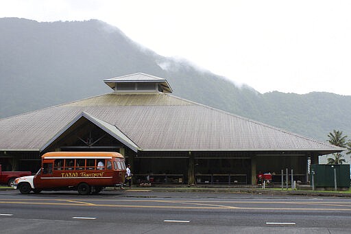 This Wednesday, March 4, 2020, photo shows a mini-bus in front of a public market place in the village of Fagatogo in Pago Pago, American Samoa. Mike Bloomberg spent more than $500 million to net one presidential primary win in the U.S. territory of American Samoa. His lone victory in the group of islands with a population of 55,000 was an unorthodox end to his much-hyped but short-lived campaign that ended Wednesday. (AP Photo/Fili Sagapolutele)