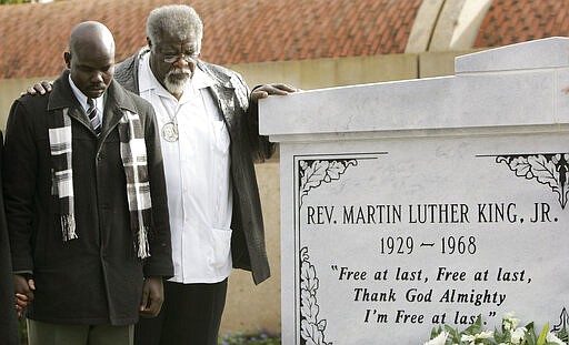 FILE - In this Jan. 12, 2007, file photo, the Rev. James Orange, right, and Obang Metho pray after helping to lay a wreath at the tombs of the Rev. Martin Luther King Jr. and his wife Coretta Scott King at the King Center for non-violent Social Change in Atlanta. When students began skipping school to join the marches, authorities arrested Orange on Feb. 18, 1965, for contributing to the?delinquency?of minors. (AP Photo/John Bazemore, File)