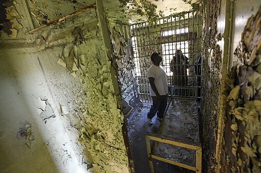 In this Feb. 29, 2020, photo, Cleon Orange looks around the Perry County Jail cell in Marion, Ala., where his father, the Rev. James Orange, a project coordinator for the Southern Christian Leadership Conference, was housed in 1965 after his arrest while organizing a voter registration drive. Orange was held on charges of disorderly conduct and contributing to the delinquency of minors. (AP Photo/Julie Bennett)