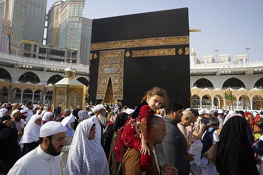 A relatively few number of Muslims pray around the Kaaba, the cubic building at the Grand Mosque, in the Muslim holy city of Mecca, Saudi Arabia, Thursday, March 5, 2020. Saudi Arabia's Deputy Health Minister Abdel-Fattah Mashat was quoted on the state-linked news site Al-Yaum saying that groups of visitors to Mecca from inside the country would now also be barred from performing the pilgrimage, known as the umrah. (AP Photo/Amr Nabil)