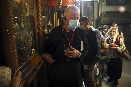 People visit the Church of the Nativity in Bethlehem, West Bank, Thursday, March 5, 2020. Palestinian authorities said the Church of the Nativity in Bethlehem, built atop the spot where Christians believe Jesus was born, will close indefinitely due to coronavirus concerns. (AP Photo/Mahmoud Illean)