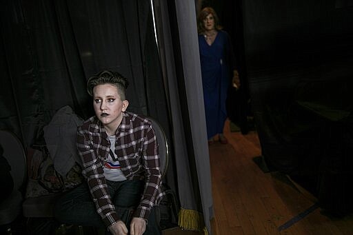 Leon Dell'era, 15, left, waits backstage for his turn to walk the runway while Lisa Smith, 70, emerges from the dressing rooms on Friday, Jan. 31, 2020, in Boston. For many years, the TransFORMED fashion show featured male-to-female crossdressers. But over time, the focus has become less about the clothes, and more about the people in them. (AP Photo/Wong Maye-E)