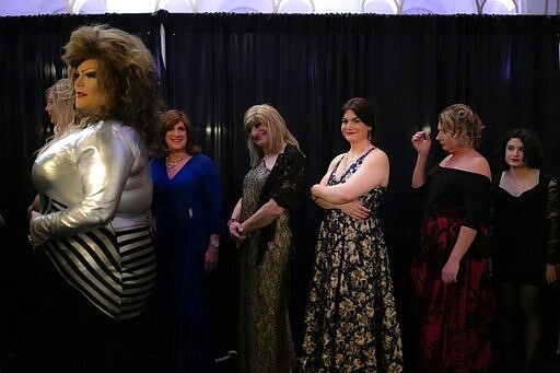 From left, Deborah Smith; Anthony Bovenzi, aka Nikita Le Femme; Lisa Smith; Samantha Ambrose; Juliana Wall; Phoebe Winter; and Sarah Langer wait to walk down the runway during the TransFORMED fashion show on Friday, Jan. 31, 2020, in Boston. For this event, models get to walk down the runway three times, dressed in three different themes of their choosing. The list includes: Role Model, Hero, Evening of Elegance, Fantasy and Hobby. (AP Photo/Wong Maye-E)