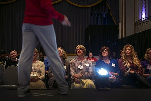 From right, Deborah Smith, Lisa Smith and Bobbi Waite watch attentively as a volunteer demonstrates the catwalk for these models for the TransFORMED fashion show on Friday, Jan. 31, 2020, in Boston. (AP Photo/Wong Maye-E)