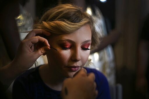 A makeup artist attaches false eyelashes on Asher, 12, during preparations for a fashion show on Friday, Jan. 31, 2020, in Boston. Asher identifies as non-binary and preferred pronoun is just &quot;Asher.&quot; (AP Photo/Wong Maye-E)