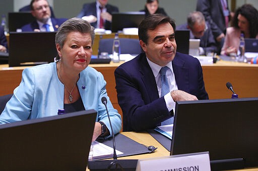 European Commissioner for Home Affairs Ylva Johansson, left, and European Commissioner for Promoting our European Way of Life Margaritas Schinas wait for the start of a meeting of EU Interior Ministers in Brussels, Wednesday, March 4, 2020. Greek authorities fired tear gas and stun grenades Wednesday morning to repulse a push by migrants to cross its land border from Turkey, as pressure continued along its frontier after Turkey said its own border with Europe was open to whoever wanted to cross. (AP Photo/Olivier Matthys)