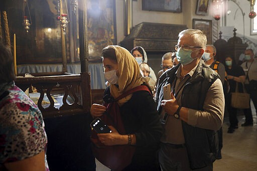 People visit the Church of the Nativity in Bethlehem, West Bank, Thursday, March 5, 2020. Palestinian authorities said the Church of the Nativity in Bethlehem, built atop the spot where Christians believe Jesus was born, will close indefinitely due to coronavirus concerns. (AP Photo/Mahmoud Illean)