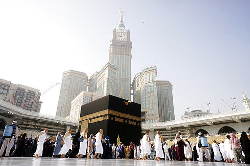 A relatively few number of Muslims pray around the Kaaba, the cubic building at the Grand Mosque, in the Muslim holy city of Mecca, Saudi Arabia, Thursday, March 5, 2020. Saudi Arabia's Deputy Health Minister Abdel-Fattah Mashat was quoted on the state-linked news site Al-Yaum saying that groups of visitors to Mecca from inside the country would now also be barred from performing the pilgrimage, known as the umrah. (AP Photo/Amr Nabil)