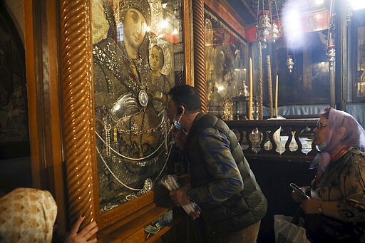 People visit the Church of the Nativity in Bethlehem, West Bank, Thursday, March 5, 2020. Palestinian authorities said the Church of the Nativity in Bethlehem, built atop the spot where Christians believe Jesus was born, will close indefinitely due to coronavirus concerns. (AP Photo/Mahmoud Illean)