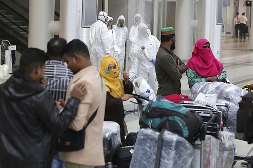 Workers wearing protective gear spray disinfectant as a precaution against the coronavirus outbreak, in the departure terminal at the Rafik Hariri International Airport, in Beirut, Lebanon, Thursday, March 5, 2020. The novel coronavirus has infected more than 80,000 people globally, causing around 2,700 deaths, mainly in China. (AP Photo/Hassan Ammar)