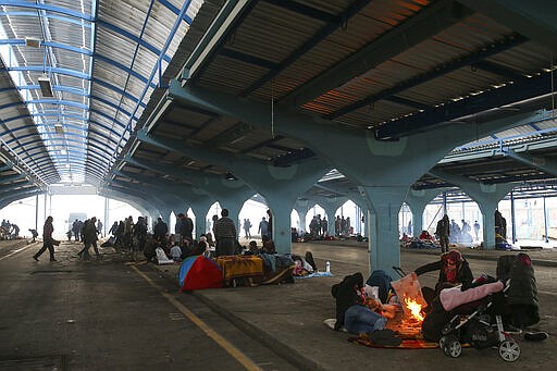 Migrants camp in a city market area in Edirne near the Turkish-Greek border on Thursday, March 5, 2020. Greece countered accusations from Turkey Wednesday that it was responsible for the death of a migrant, as its border authorities strove for a sixth day to keep thousands of migrants out by using tear gas, stun grenades and water cannons.AP Photo/Emrah Gurel)