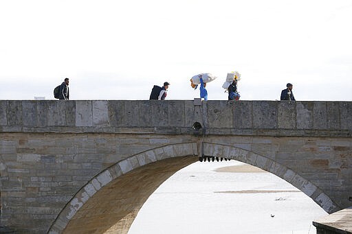 Migrants walk on a bridge in Edirne near the Turkish-Greek border on Thursday, March 5, 2020. Turkey has vowed to seek justice for a migrant it says was killed on the border with Greece after Greek authorities fired tear gas and stun grenades to push back dozens of people attempting to cross over. Greece had denied that anyone was killed in the clashes. (AP Photo/Darko Bandic)