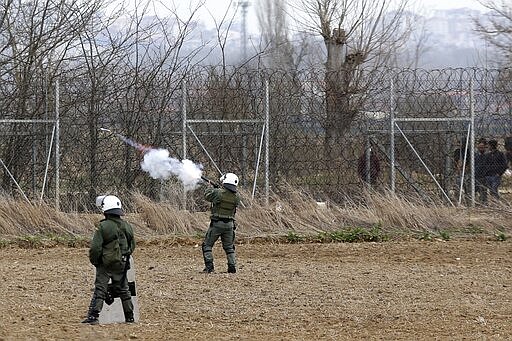 Greek riot police fire tear gas at migrants who try to enter Greece from Turkey at the Greek-Turkish border in Kastanies on Wednesday, March 4, 2020. Facing a potential wave of nearly a million people fleeing fighting in northern Syria, Turkey has thrown open its borders with Greece to thousands of refugees and other migrants trying to enter Europe, and has threatened to send &quot;millions&quot; more. (AP Photo/Giannis Papanikos)