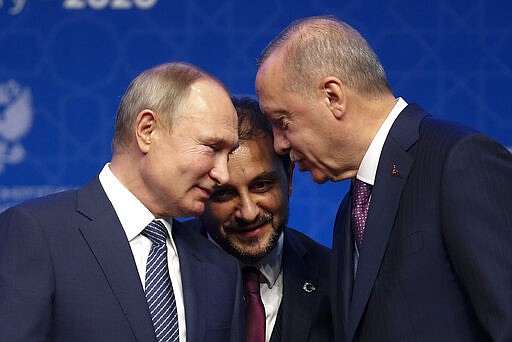 FILE - In this Jan. 8, 2020 file photo, Turkey's President Recep Tayyip Erdogan, right and Russia's President Vladimir Putin, left, talk during a ceremony in Istanbul for the inauguration of the TurkStream pipeline. A summit meeting between the Turkish and Russian leaders scheduled for Thursday, March 5, 2020, may be the last chance to work out a deal that avoids a calamity in Syria's northwest. Faced with mounting losses for his troops in Syria and a potential wave of refugees fleeing fighting in northwestern Syria, Turkish President Recep Tayyip Erdogan is eager for a cease-fire and Vladimir Putin is ready to bargain. (AP Photo/Lefteris Pitarakis, File)