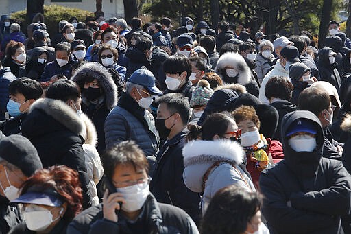 People line up to buy face masks to protect themselves from the new coronavirus outside Nonghyup Hanaro Mart in Seoul, South Korea, Thursday, March 5, 2020. The number of infections of the COVID-19 disease spread around the globe. (AP Photo/Ahn Young-joon)