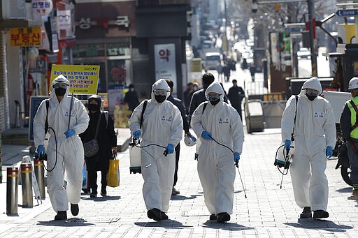 South Korean soldiers wearing protective gears spray disinfectant as a precaution against the new coronavirus in Seoul, South Korea, Thursday, March 5, 2020. The number of infections of the COVID-19 disease spread around the globe. (AP Photo/Lee Jin-man)