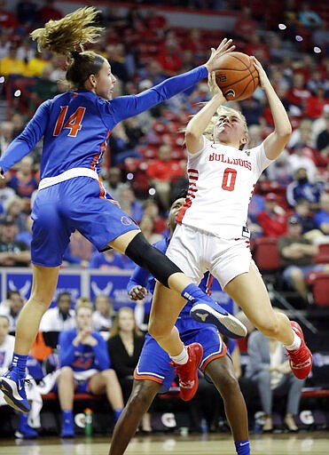 Fresno State's Hanna Cavinder (0) shoots as Boise State's Braydey Hodgins defends during the first half of an NCAA college basketball game for the Mountain West Conference women's tournament title Wednesday, March 4, 2020, in Las Vegas. (AP Photo/Isaac Brekken)