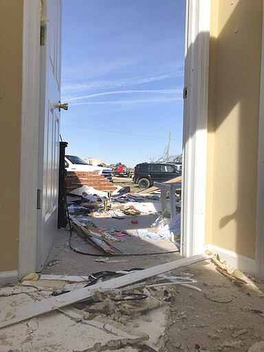 A view from the front door of Jose Cojom&#146;s tornado-wrecked home in Putnam County, Tennessee on Wednesday, March 4. After the pre-dawn tornado on Tuesday, volunteers came on Wednesday to cut apart damaged tress and sort through debris. (AP Photo/Travis Loller)