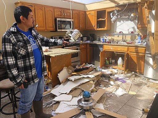 Jose Cojom shows the new granite countertops and stainless steel appliances in his kitchen on Wednesday, March 4. His Putnam County, Tennessee, home was destroyed by a tornado that came through his neighborhood before dawn on Tuesday. (AP Photo/Travis Loller)